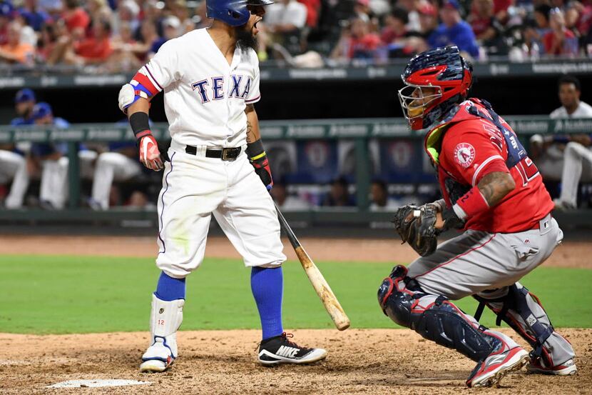 Texas Rangers' Rougned Odor voices his displeasure after being called out on strikes as Los...