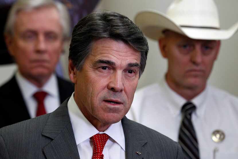 Texas Governor Rick Perry, joined by law enforcement officials at a press conference...