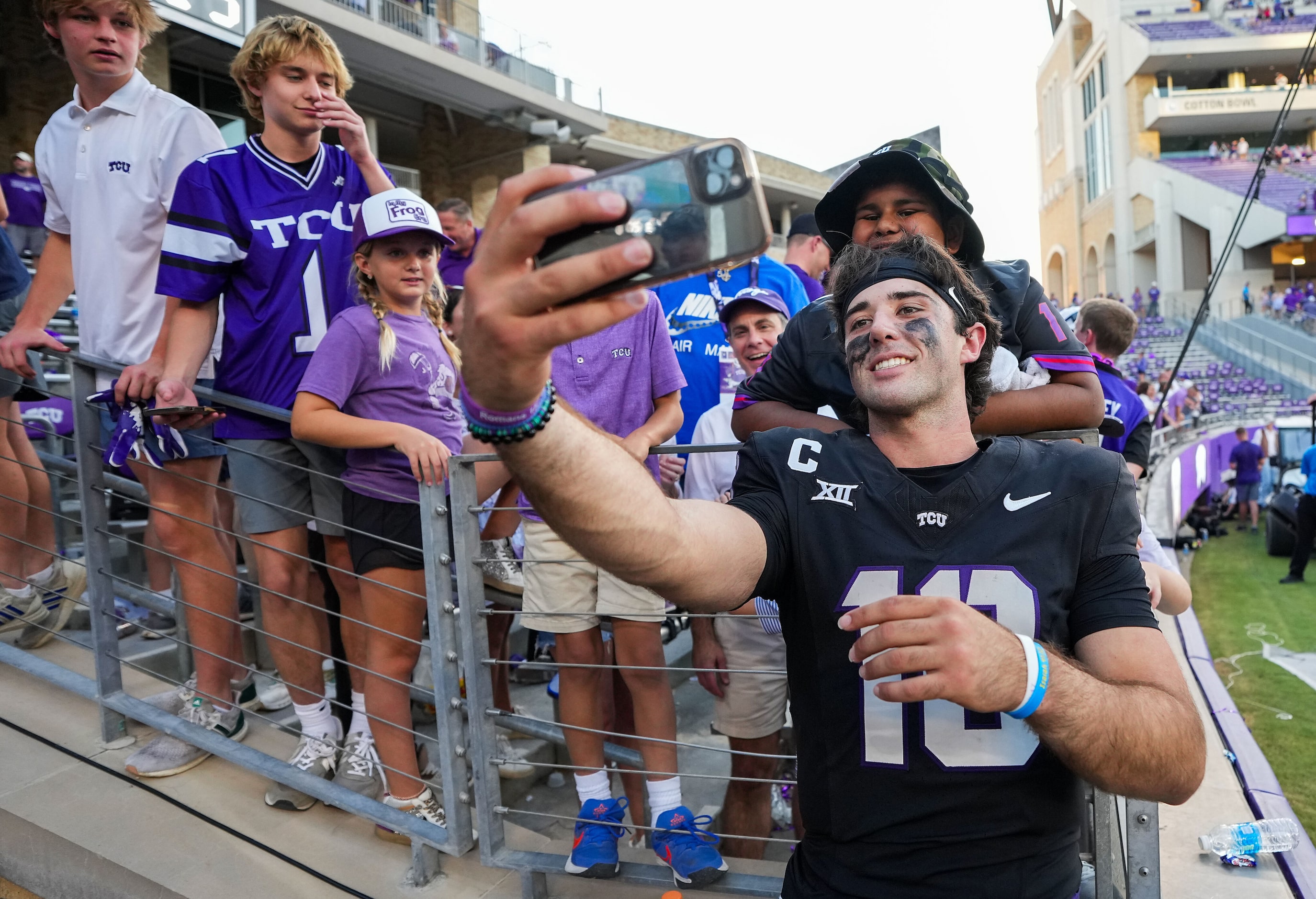 TCU quarterback Josh Hoover takes a selfie with fans after a 35-34 victory over Texas Tech...