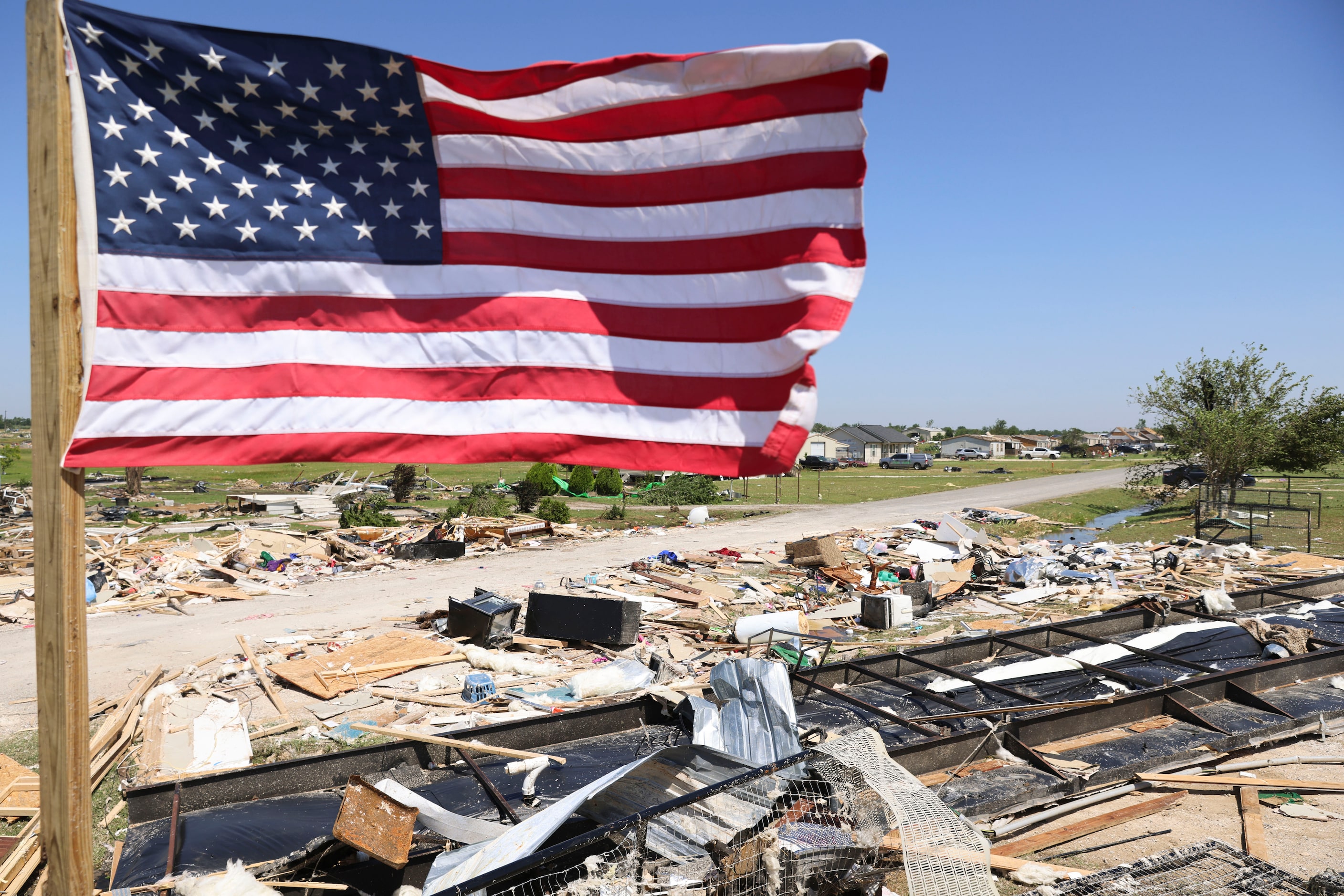 Debris scattered around W Lone Oak Rd., after a tornado moved through the area, on Sunday,...