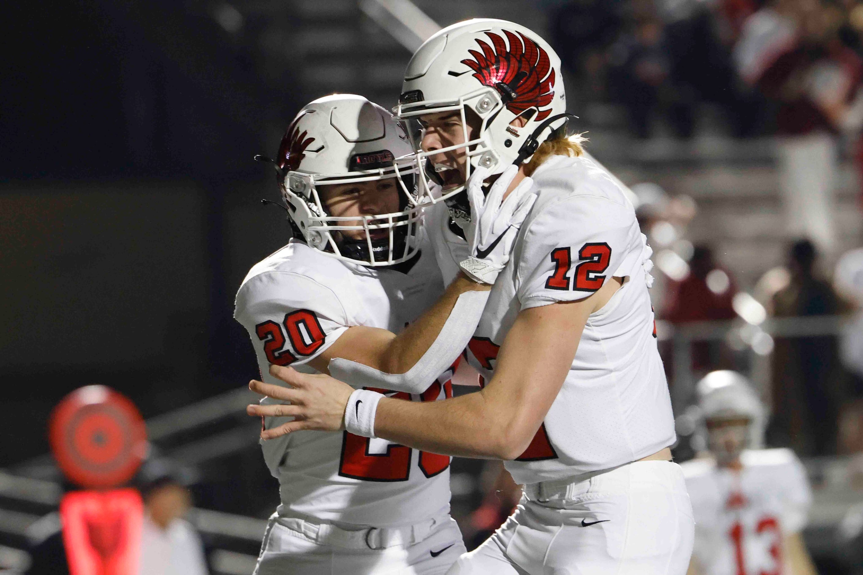 Argyle High’s Landon Farris (20) and John Gailey (12) celebrates a touchdown during the...