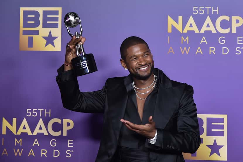 Usher poses in the press room during the 55th NAACP Image Awards on Saturday, March 16,...