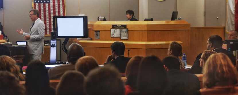 Defense attorney Andy Beach (left) makes his final argument in the capital murder trial for...