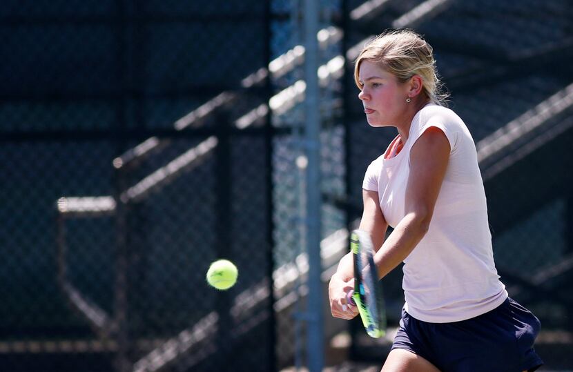 Highland Park's Lizanne Boyer hits the ball during tennis practice at Seay Tennis Center in...