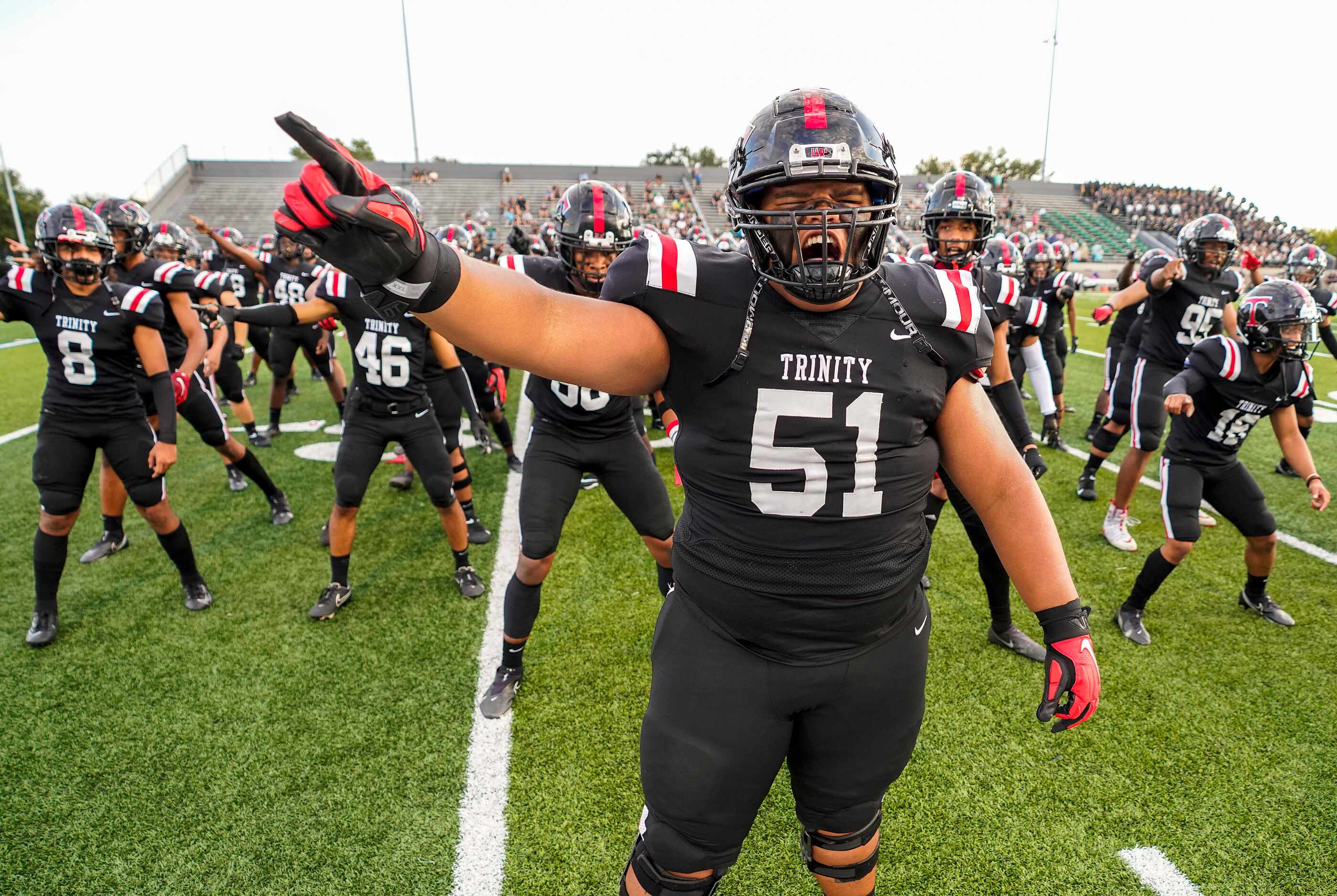 Euless Trinity offensive lineman Peni Masima (51) leads teammates as they do the Sipi Tau...