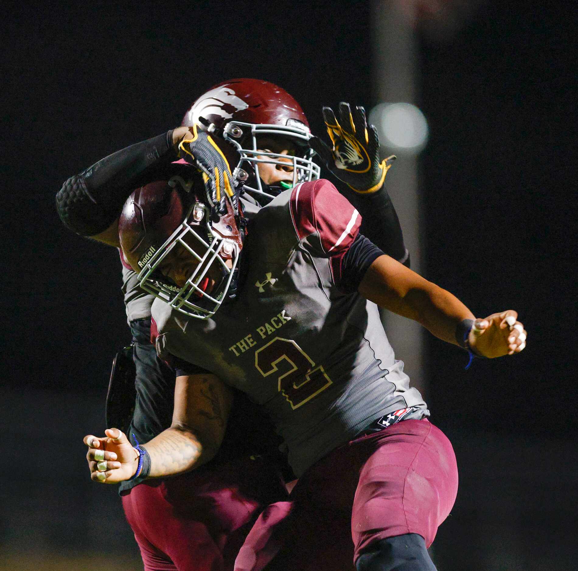 Mansfield Timberview linebacker Joel Ardern (2) celebrates a sack with defensive lineman...