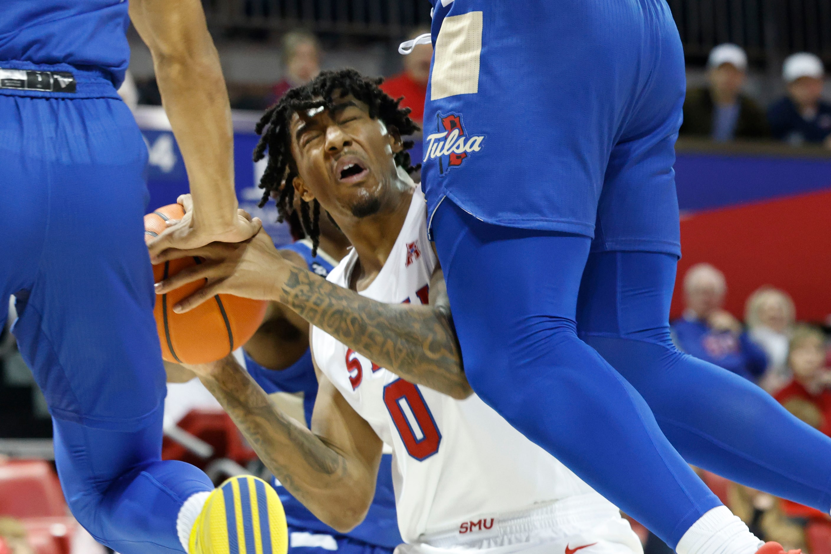 Southern Methodist guard B.J. Edwards (0) is fouled by Tulsa forward Matt Reed (right)...