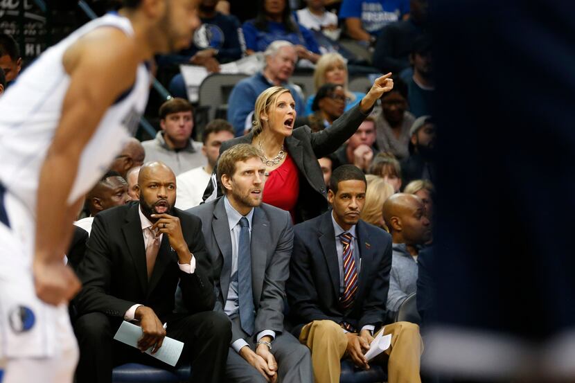 Dallas Mavericks assistant coaches Jamahl Mosley (left) and Stephen Silas sit alongside Dirk...