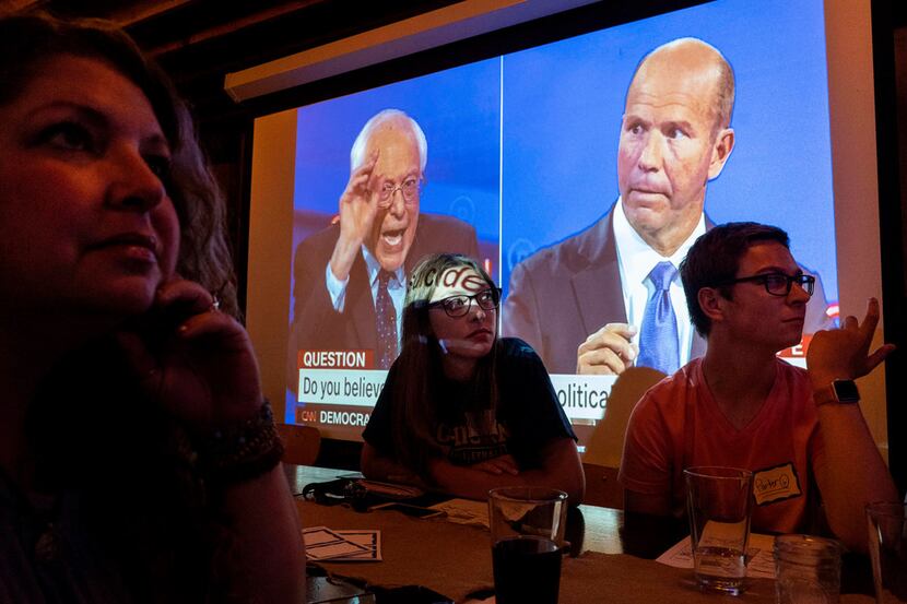High school students and supporters of Jody LaMacchia watch a 2020 Democratic presidential...