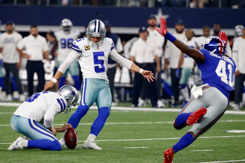 Dallas Cowboys' Chris Jones (6) holds as place kicker Dan Bailey (5) kicks a field goal...