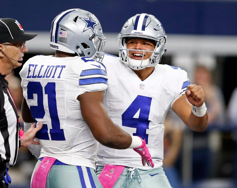 Dallas Cowboys quarterback Dak Prescott (4) congratulates Dallas Cowboys running back...