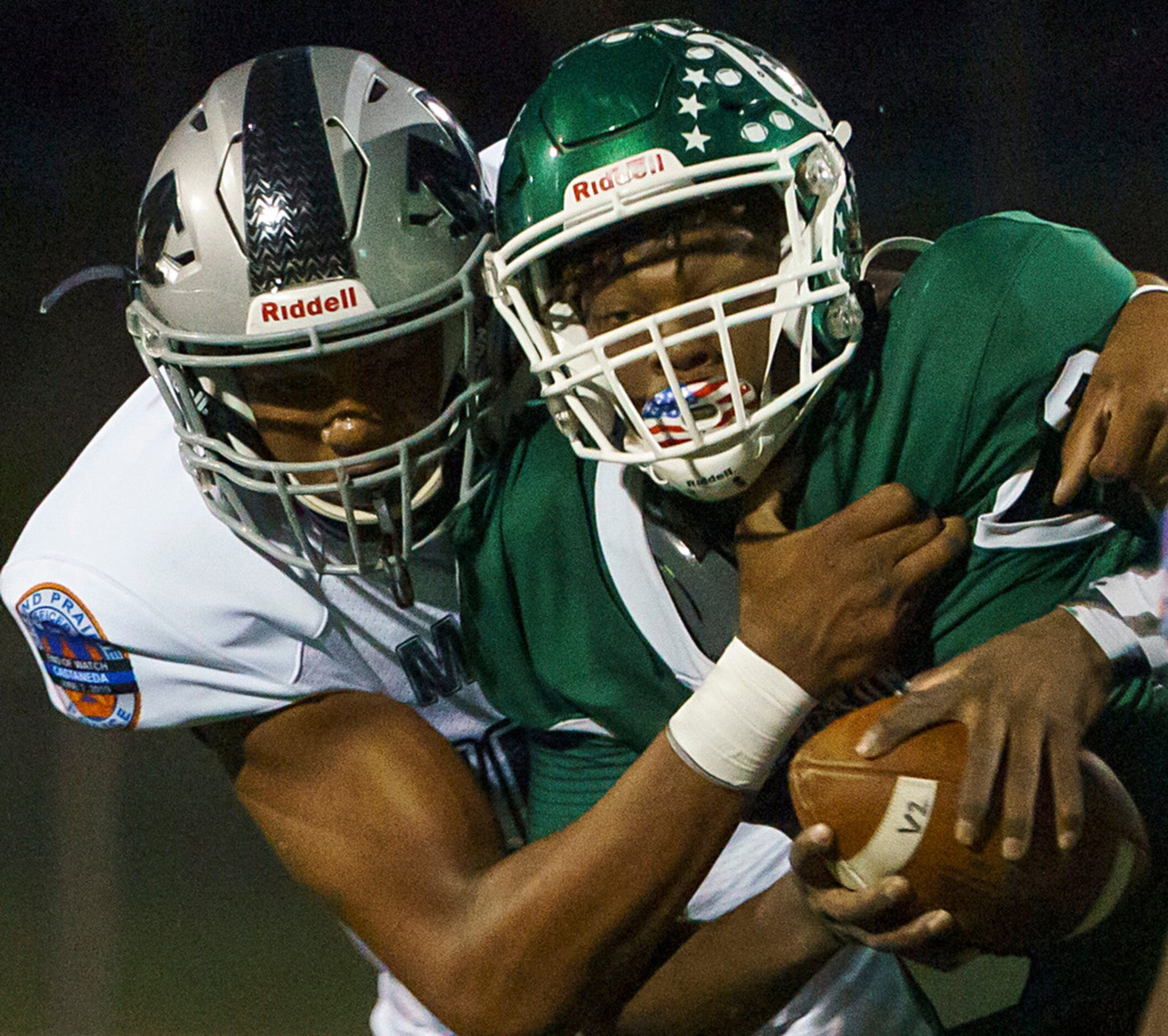 Arlington quarterbck Kris Sims (8) is brought down by Arlington Martin defensive lineman...