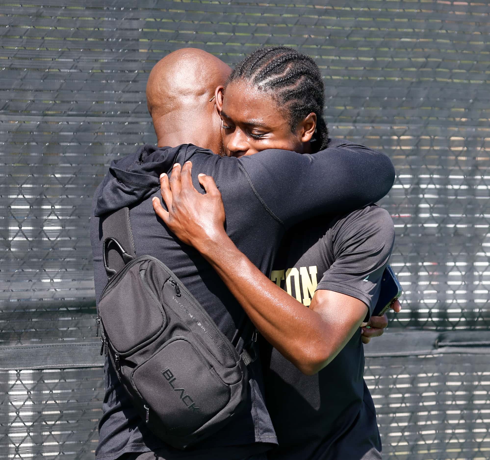 Malcolm Moore, Dallas Pinkston is comforted by his dad Eric Moore after he was defeated by...