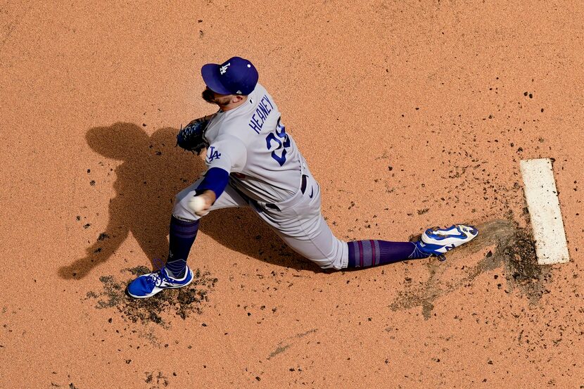 Los Angeles Dodgers starting pitcher Andrew Heaney throws during the first inning of a...