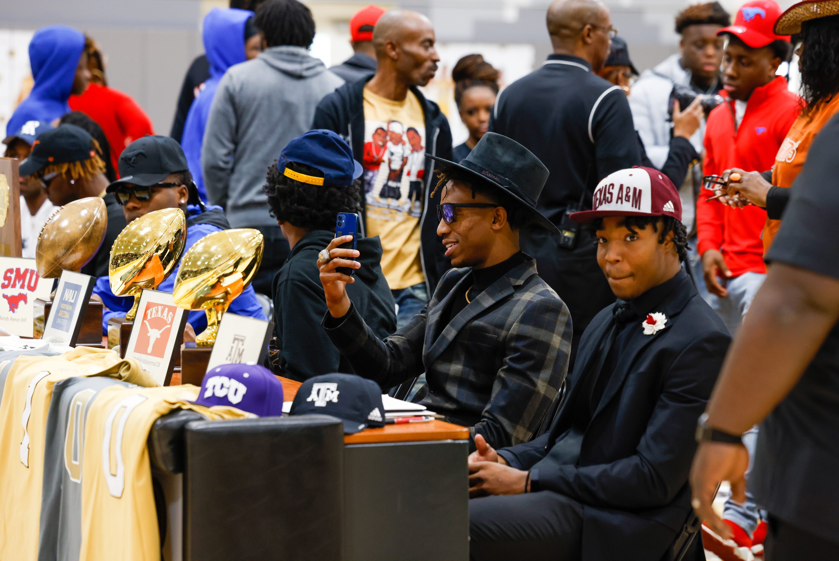 South Oak Cliff football player Manny (Malik) Muhammad (center) takes a selfie as teammate...