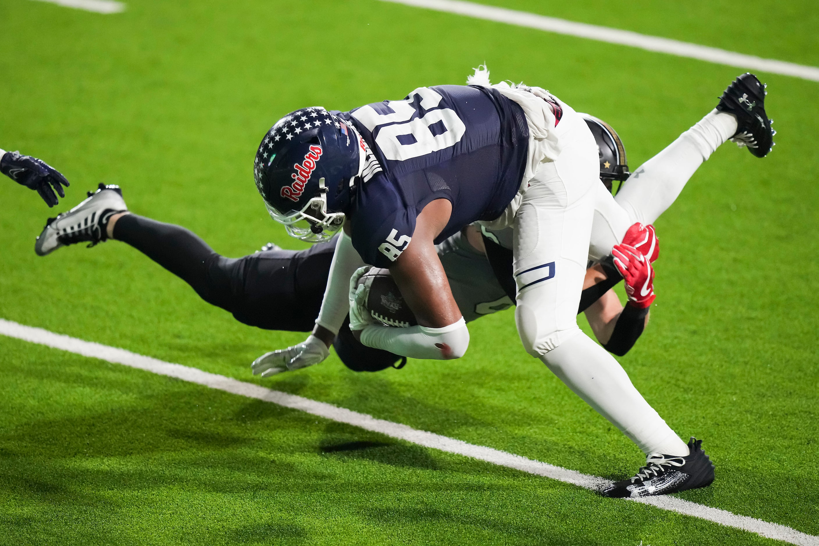 Denton Ryan’s Jose Melendez (85) is brought down by The Colony defensive back Sean Keenen...