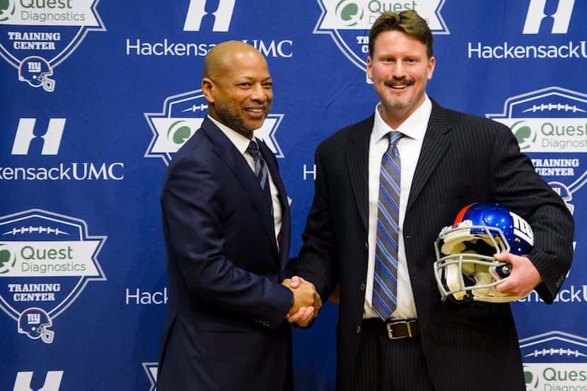 Ben McAdoo, newly appointed as the New York Giants head coach, shakes hands with General...
