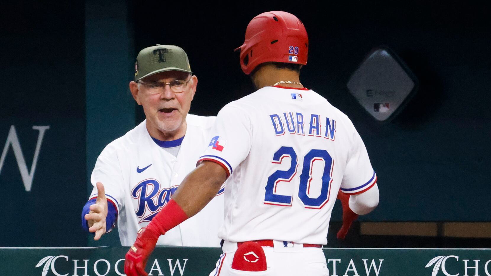Texas Rangers manager Bruce Bochy (left) cheers with shortstop Ezequiel Duran after a homer...