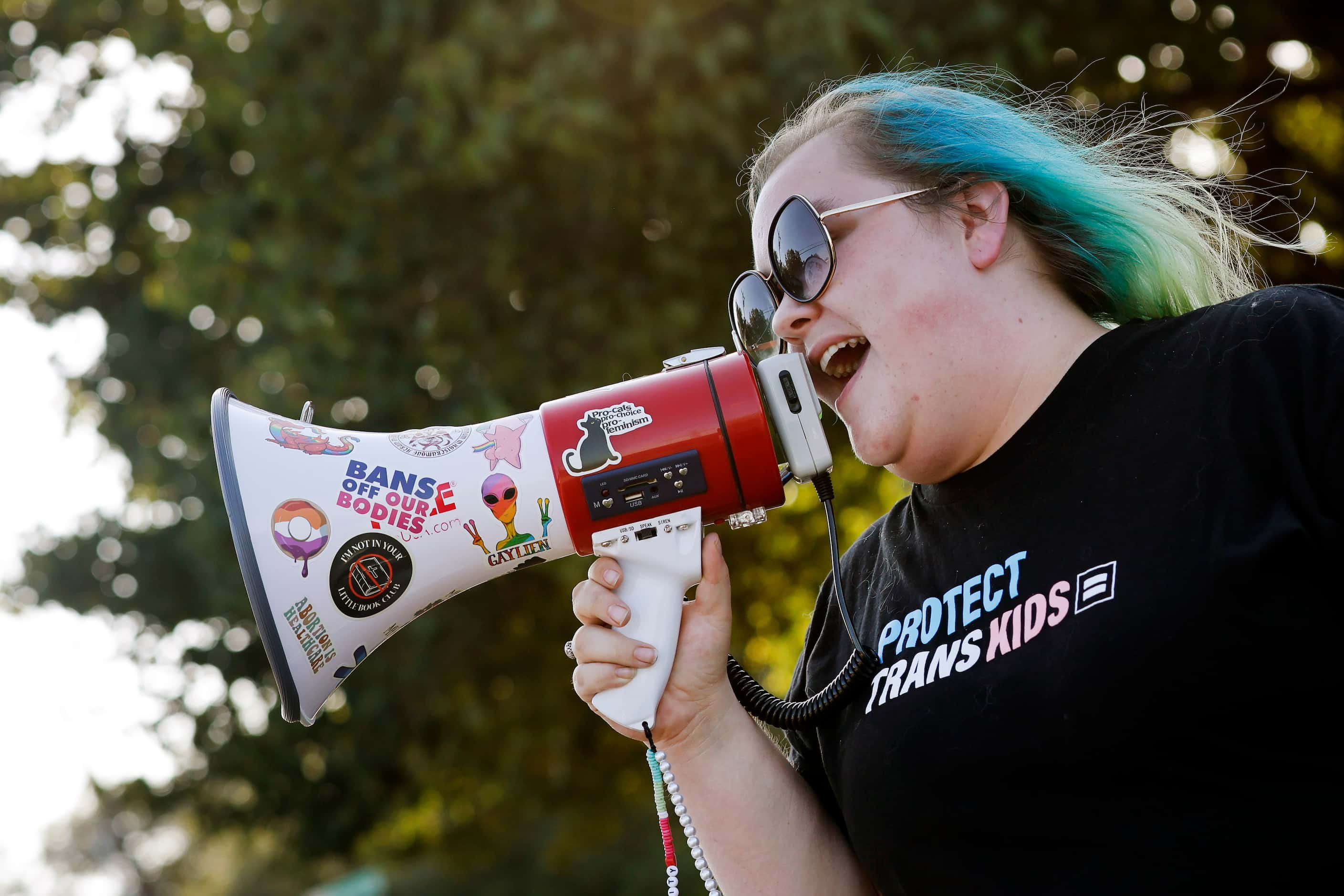 Protestor Erica Knight of No Hate In Texas uses a bullhorn to chant and yell at New...