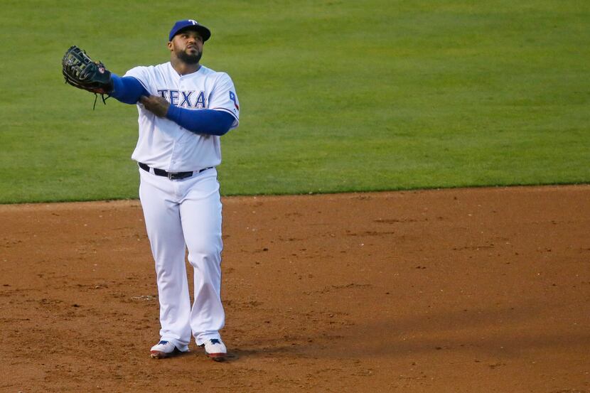 Texas first baseman Prince Fielder glances at the scoreboard during a prolonged top of the...