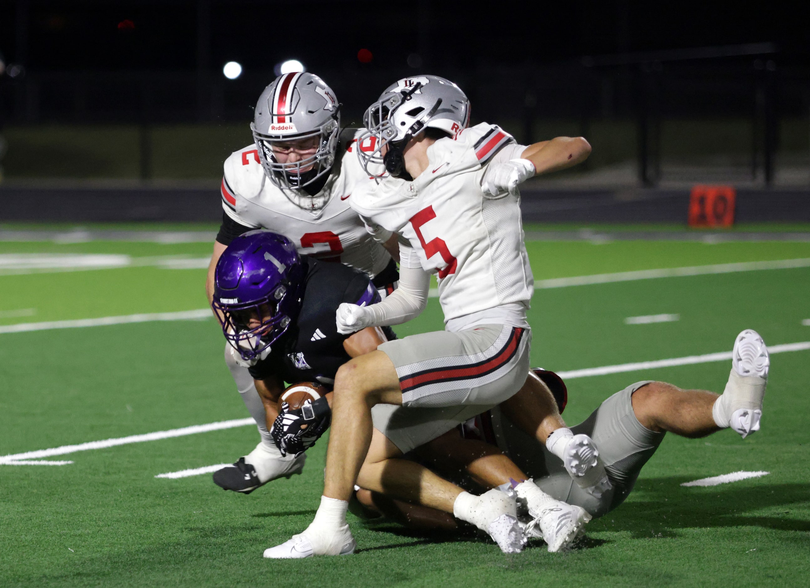 Anna player #1 Edward Chumley is pulled down by multiple Lovejoy players during the Lovejoy...