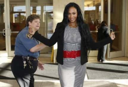  Collin County security guard by Rebecca Williams, left, screens Pilar Sanders after...