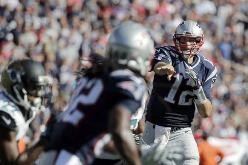 New England Patriots quarterback Tom Brady (12) throws a touchdown pass to wide receiver...