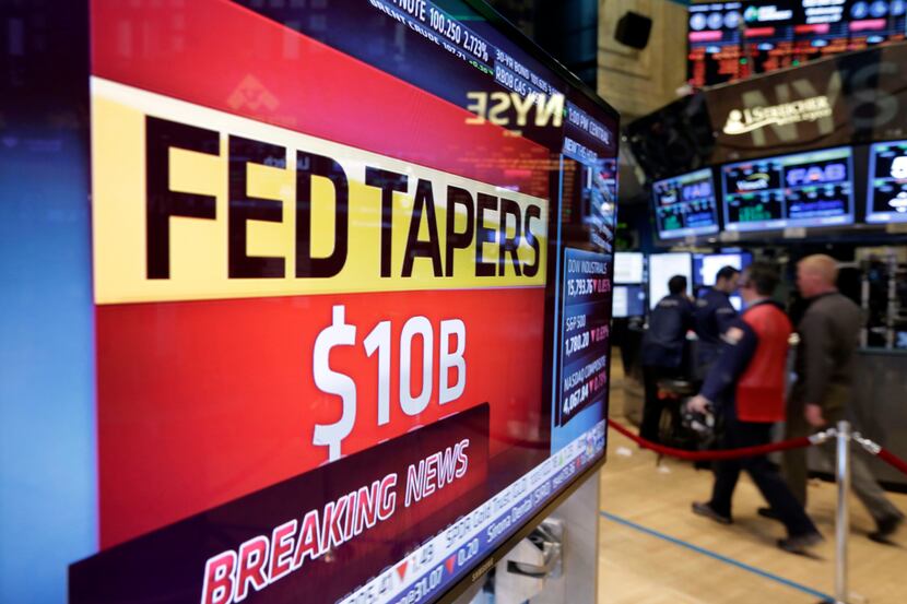 A television screen on the floor of the New York Stock Exchange shows the decision of the...