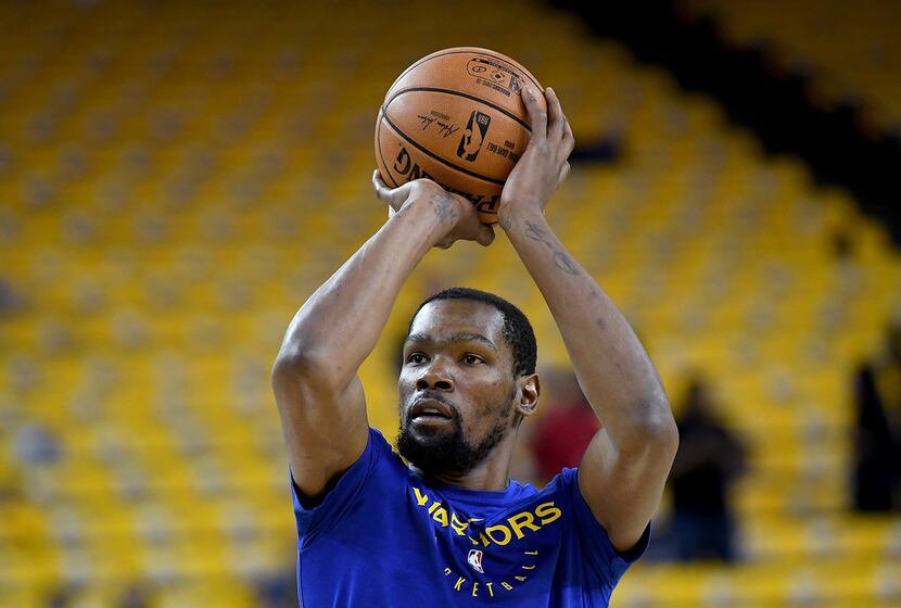 OAKLAND, CA - APRIL 28:  Kevin Durant #35 of the Golden State Warriors warms up shooting...