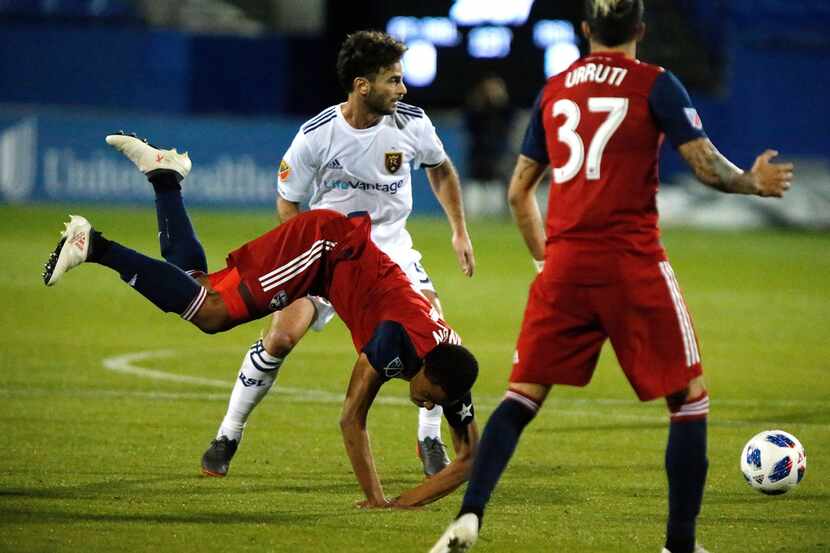 FC Dallas defender Reggie Cannon (2) goes down in front of Real Salt Lake midfielder Kyle...