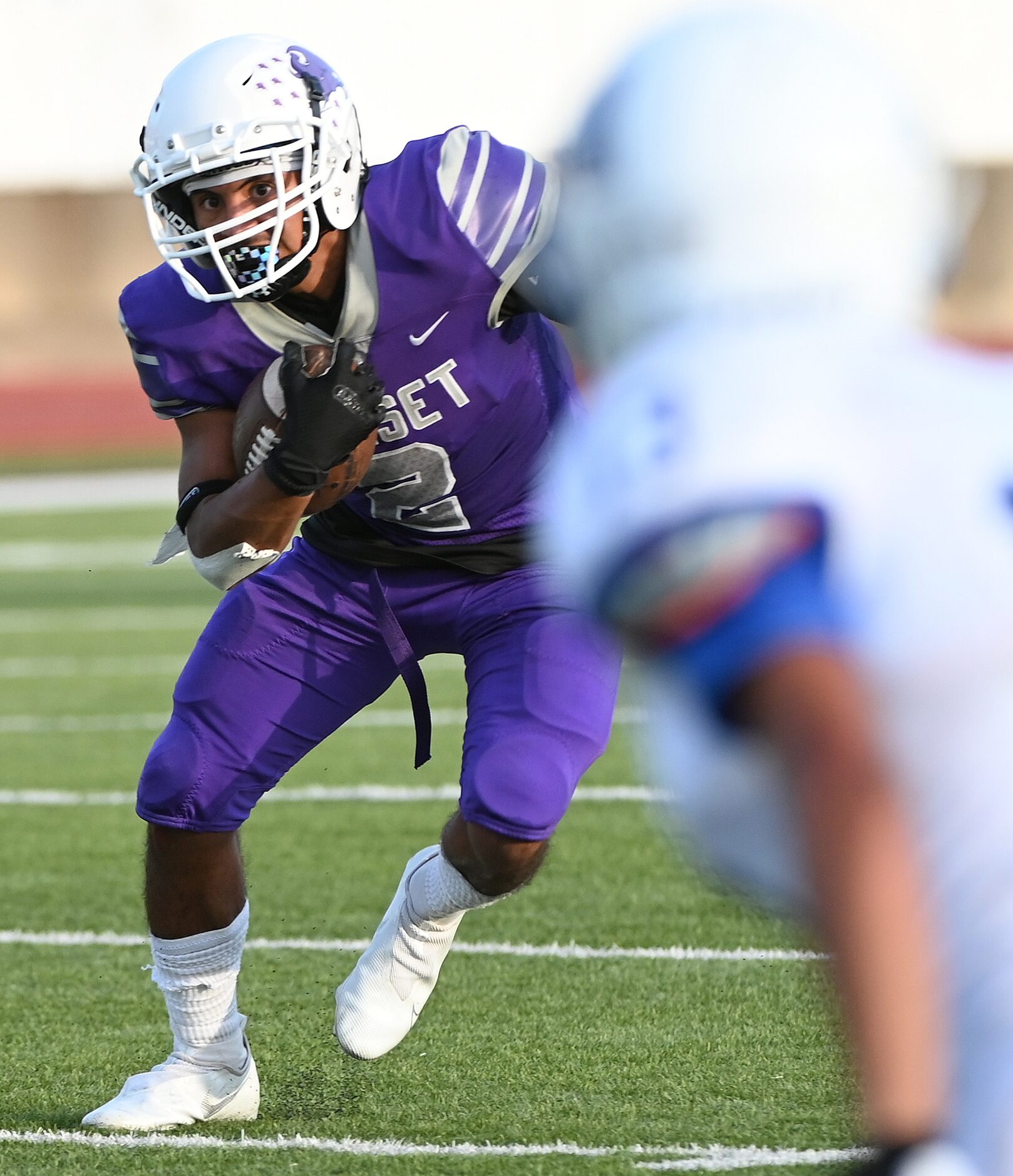 Sunset's Elias Guerrero (2) runs upfield in the first half during a high school football...