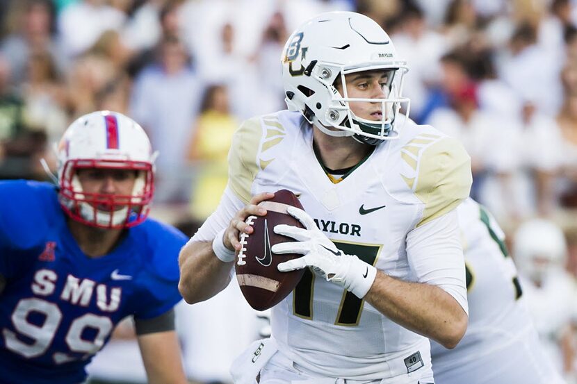 Baylor quarterback Seth Russell (17) looks for a receiver under pressure from SMU defensive...