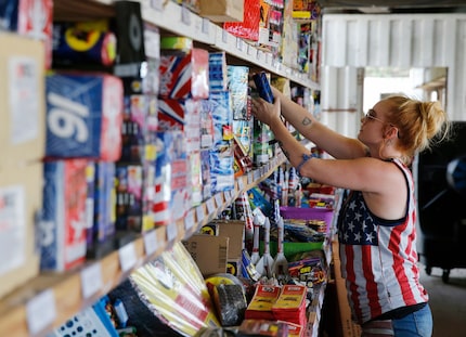 Dana Delgado restocks fireworks at Starr Fireworks in Kaufman County. Delgado has worked at...