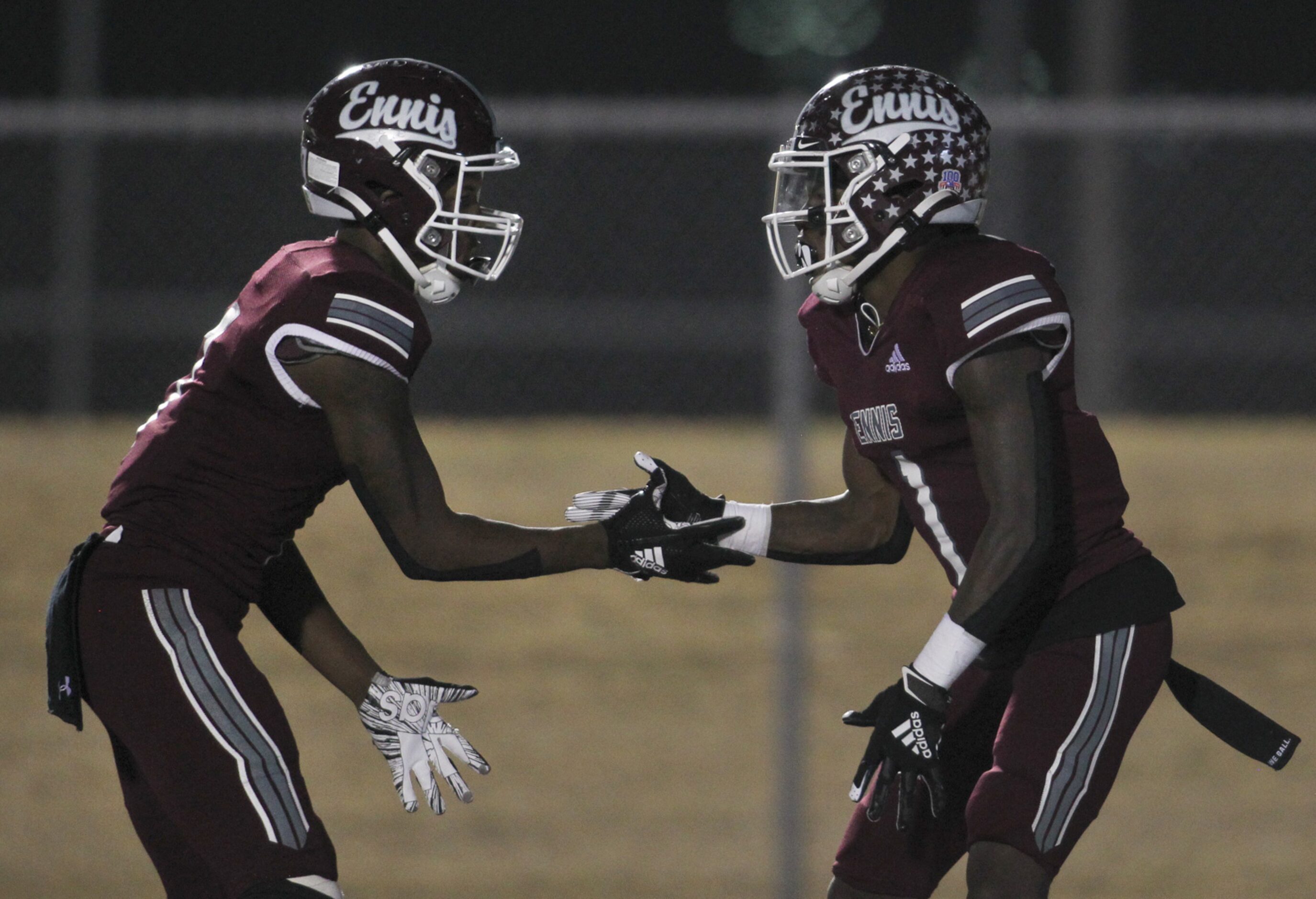 Ennis receiver Karon Smith (1), right, celebrates with receiver Laylon Spencer (7),...