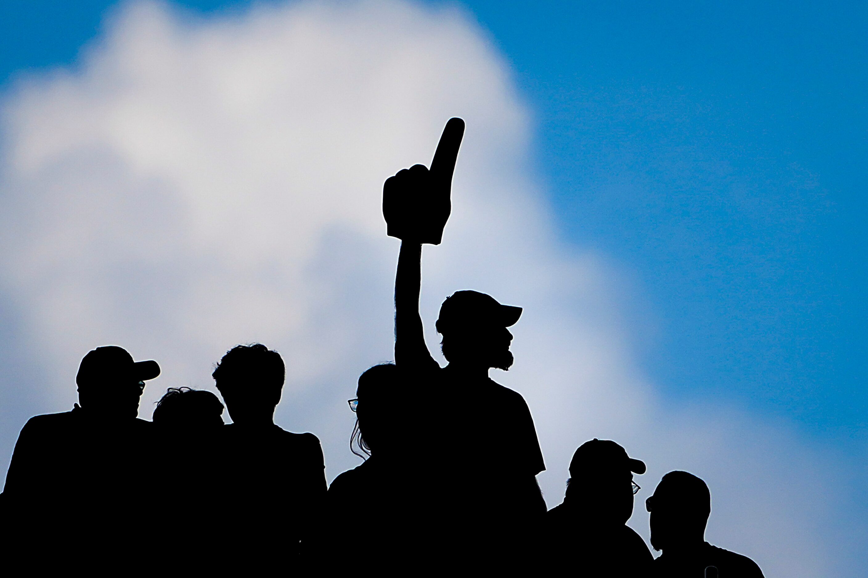 Dallas Cowboys fans cheer against the clear sky through the open end zones during the first...