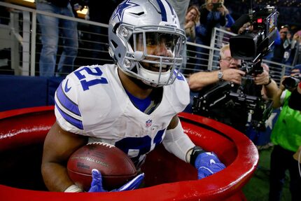 The Cowboys' Ezekiel Elliott jumped into a Salvation Army red kettle to celebrate a...