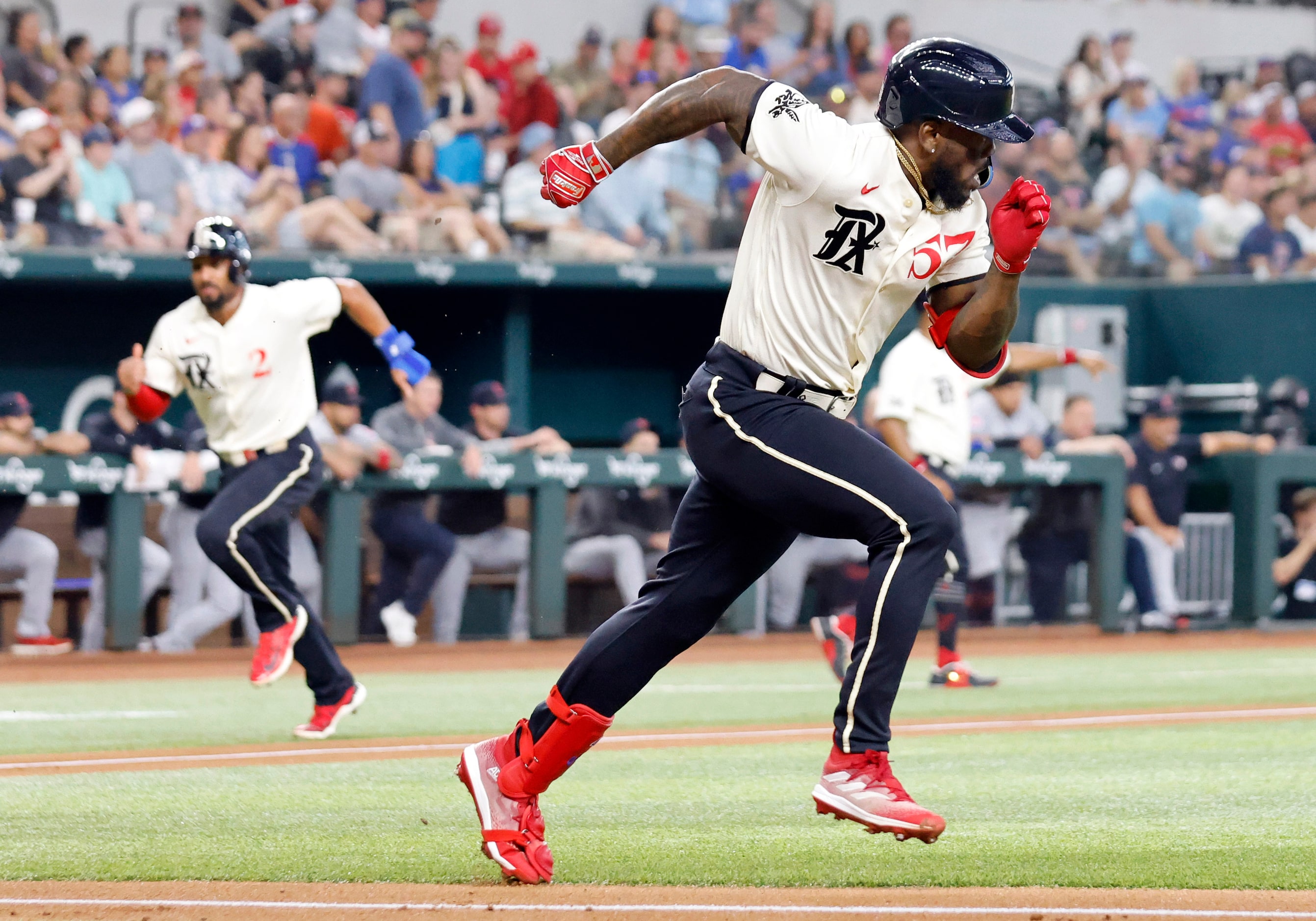 Texas Rangers right fielder Adolis Garcia (53) runs to first as Marcus Semien (background)...