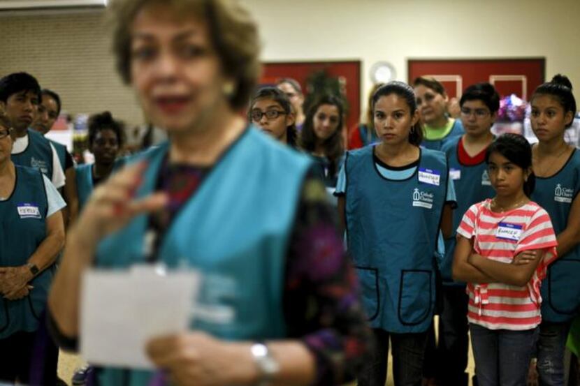 
New volunteers receive an orientation at the Sacred Heart Catholic Church in McAllen,...