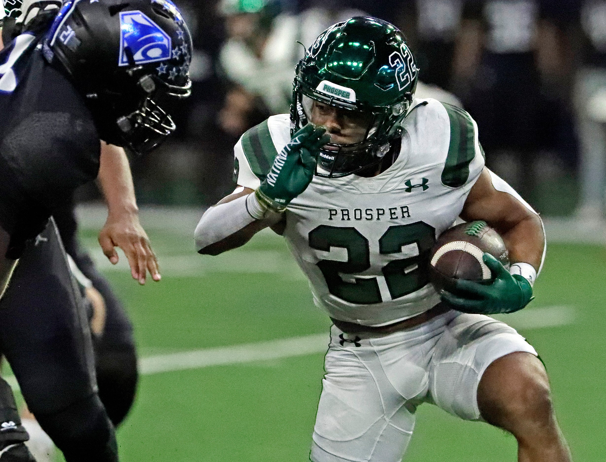 Prosper High School running back Leonel Anguiano (22) looks for room to run during the first...