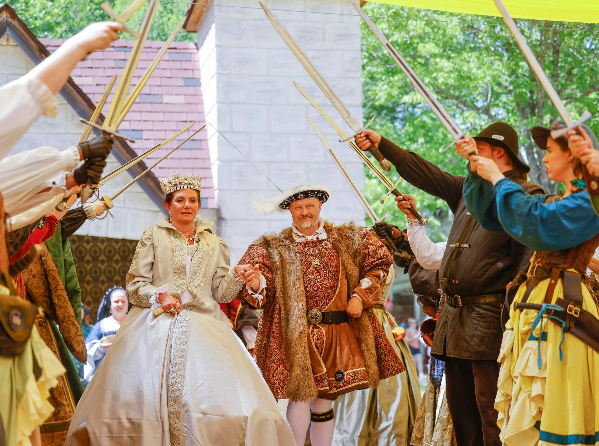 Janna Zepp, playing Queen Catherine Parr, and Mick Moreau playing King Henry VIII, walk...