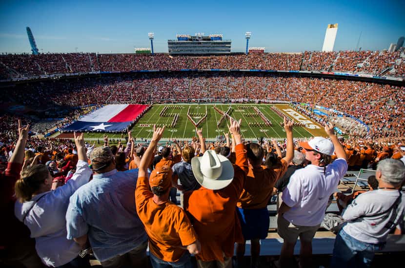 Texas Longhorns fans hookem as the Texas Longhorns band takes the field before the 2016 AT&T...