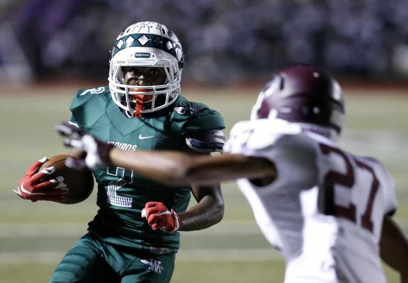 Waxahachie receiver Kenedy Snell (2) attempts to make a run past Ennis corner back Marqus...