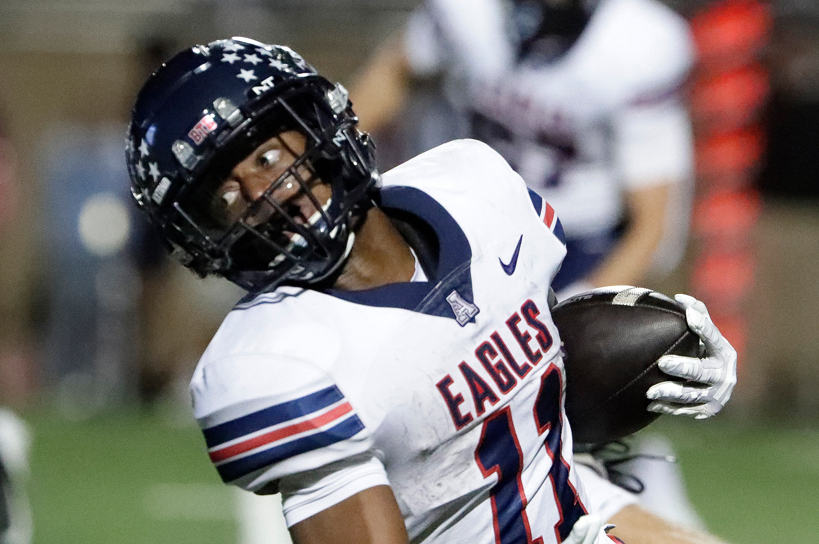 Allen High School running back Lyndon Spriggs (11) looks for extra yardage during the first...