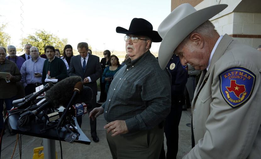David Byrnes, sheriff of Kaufman County (right), bowed his head as Kaufman County District...