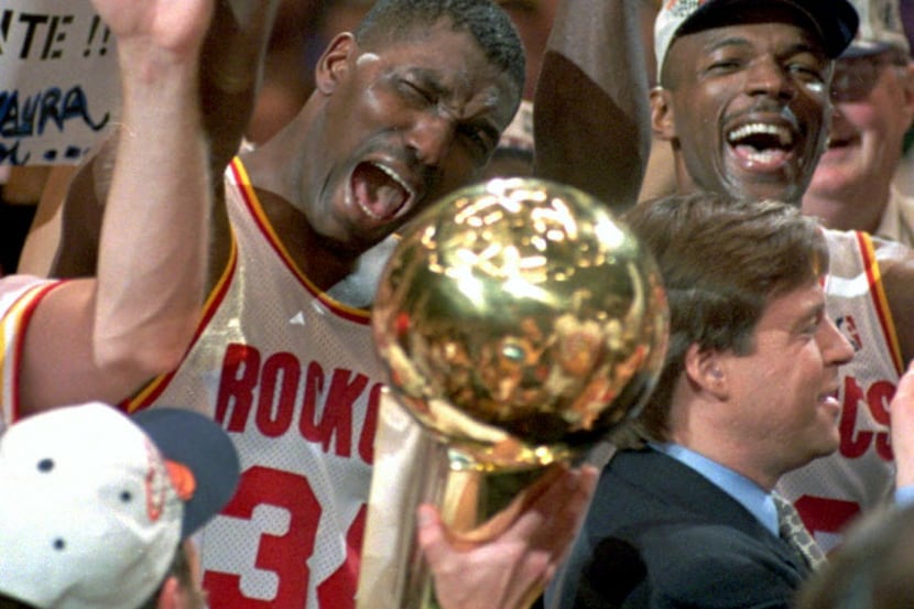 Hakeem Olajuwon, left, was pivotal to Houston's two NBA championships in the '90s and was...