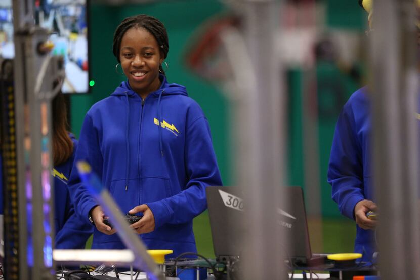 Tamrah Hughes, a sophomore at Emmett J. Conrad High School, controlled a robot during a...