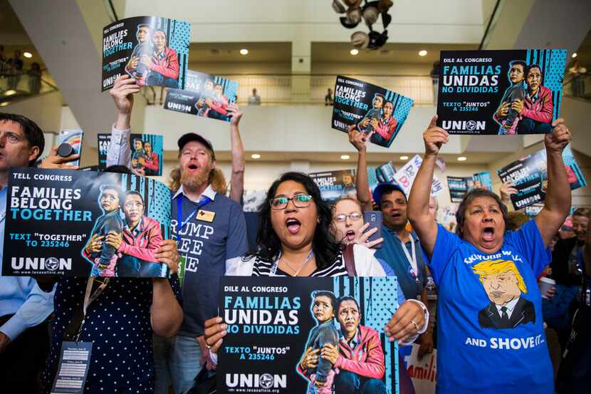 People chant and hold signs during a Families First Rally at the Texas Democratic Convention...