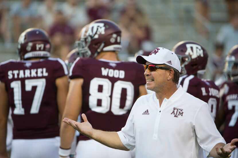 Texas A&M Aggies head coach Jimbo Fisher works with players during warmups prior to a...