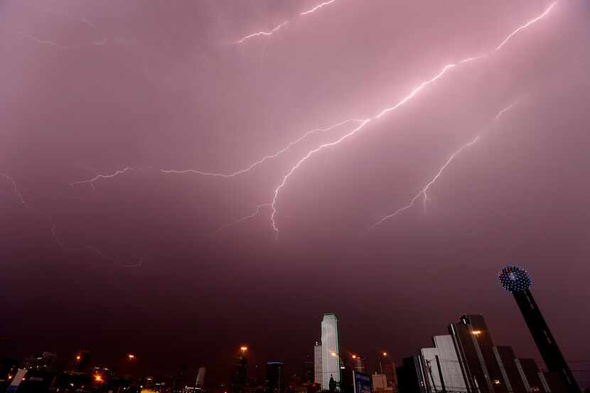 A bolt of lightning strikes over the downtown skyline in Dallas on April 26, 2016.