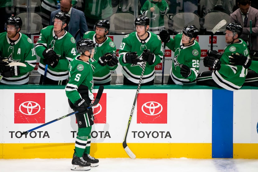 Dallas Stars defenseman Nils Lundkvist (5) fist bumps his teammates on the bench after...